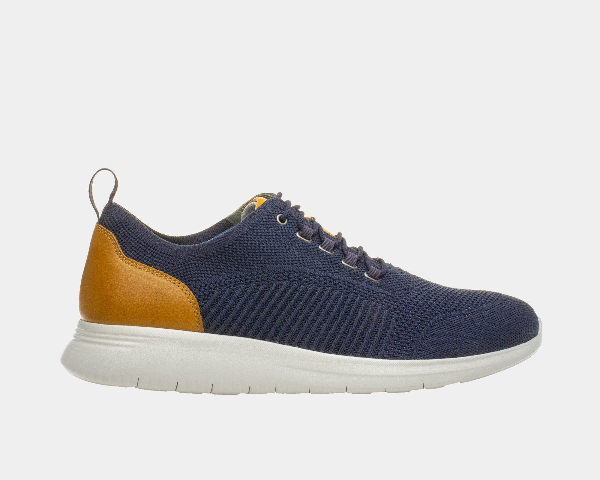 A navy dress casual style knit shoe with a leather trim and a low heel design on a flat sole.