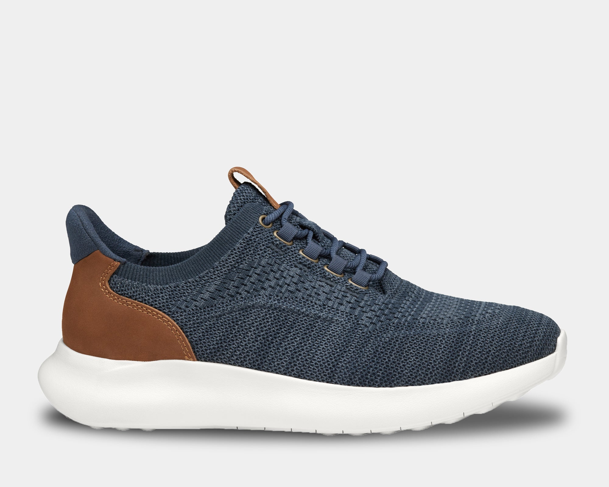 A pair of low-top athletic style knit sneakers with a plain toe design, featuring a navy heathered knit fabric, brown leather trim, and a tan heel counter.